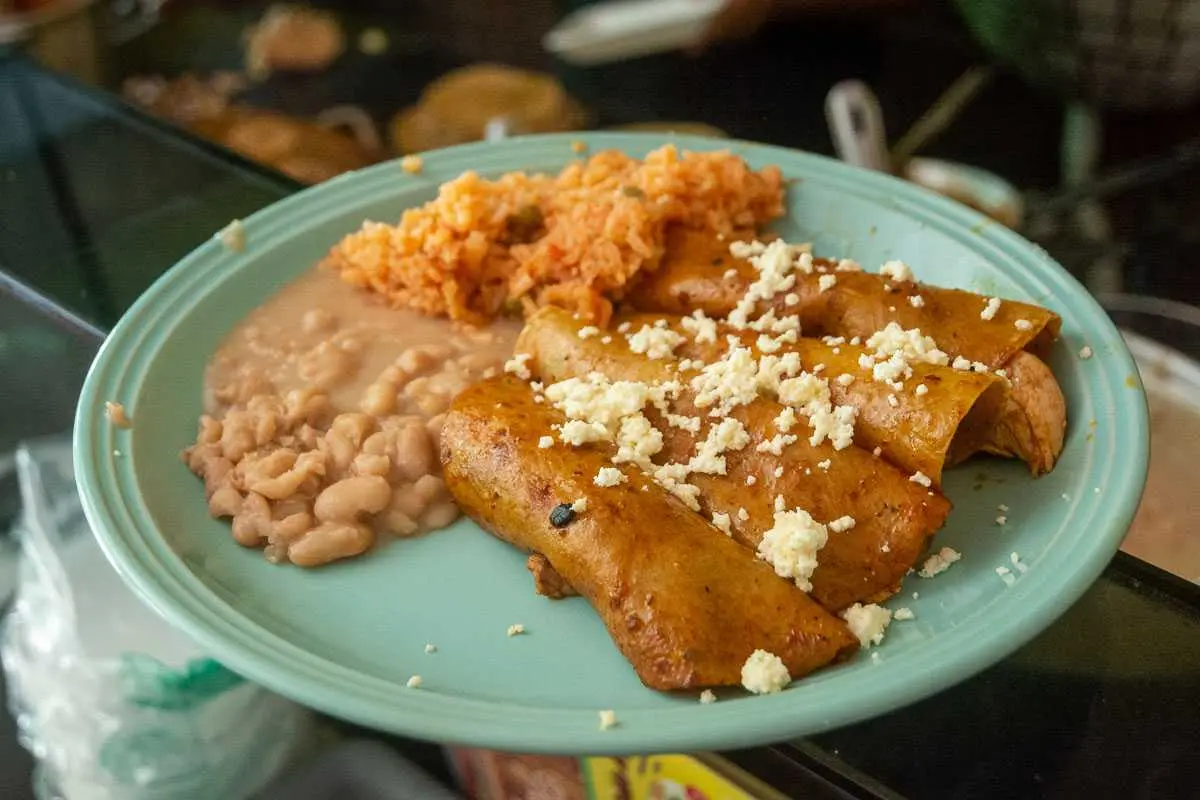 Enchiladas with beans and rice.