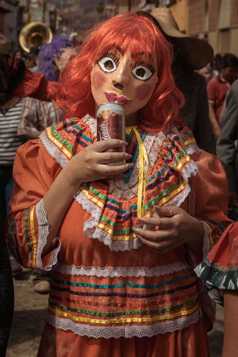 Valentina Jiménez drinks a Victoria beer during the parade.