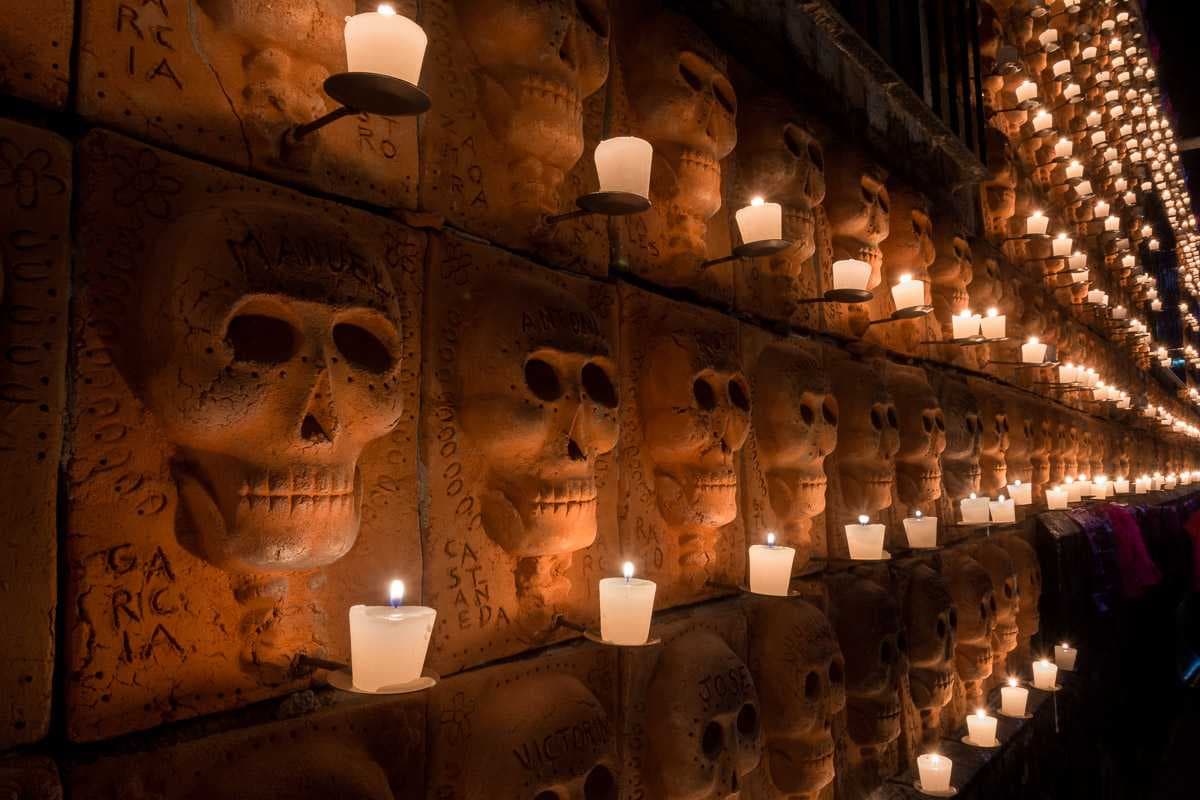 The idea for this wall of terracotta skulls, seen here illuminated by hundreds of candles on the Day of the Dead, was planned and executed by Efrén Gonzalez.