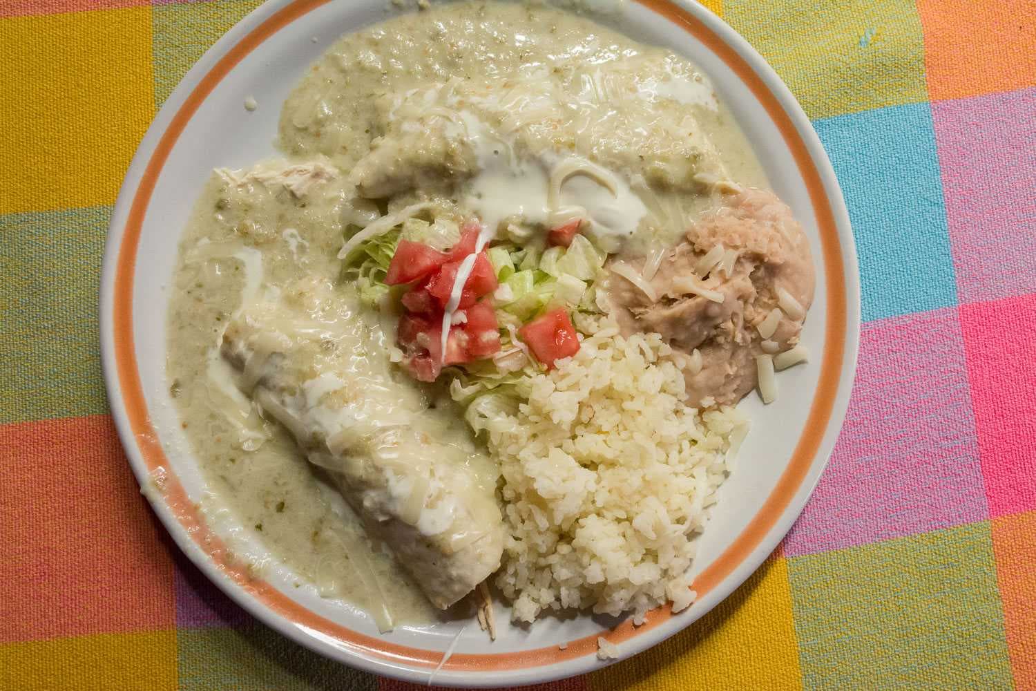 Enchiladas suizas use a tart cream- and tomatillo-based salsa that makes them a bit tart. Found at David's Café.