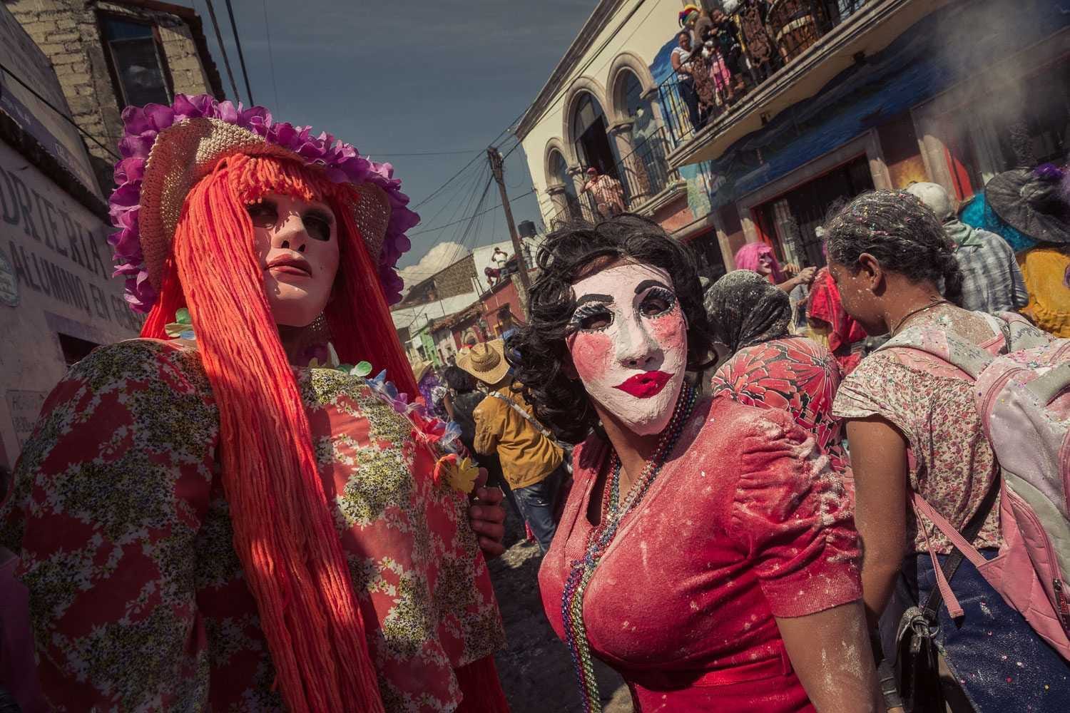 Sayacas during the Carnaval day parade. With so many floats and people, the sayacas spend more time on Carnaval day dancing and throwing flour than chasing kids through the streets.