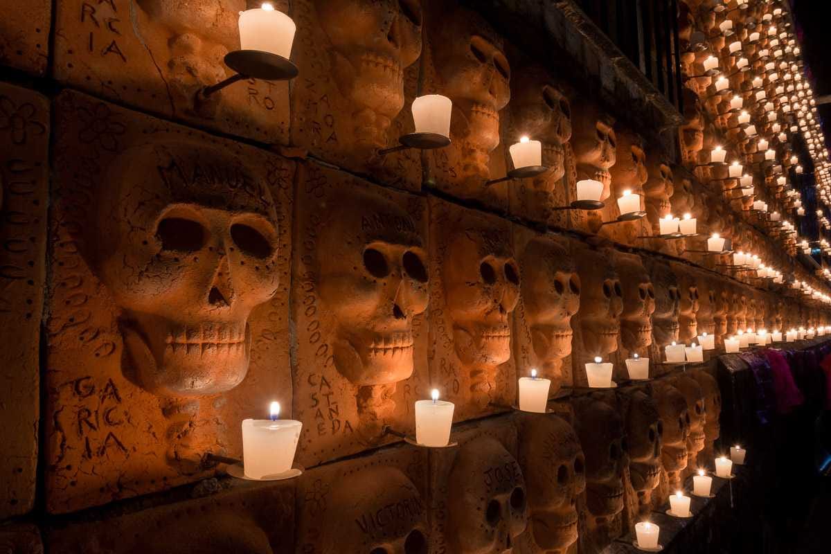 The idea for this wall of terracotta skulls, seen here illuminated by hundreds of candles on the Day of the Dead, was planned and executed by Efrén Gonzalez.