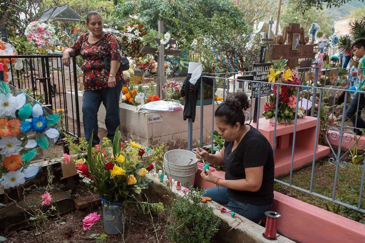 Mari Huizar cleans up and decorates her family's plot in the Ajijic cemetery. It was the first Día de los Angelitos for her daughter.