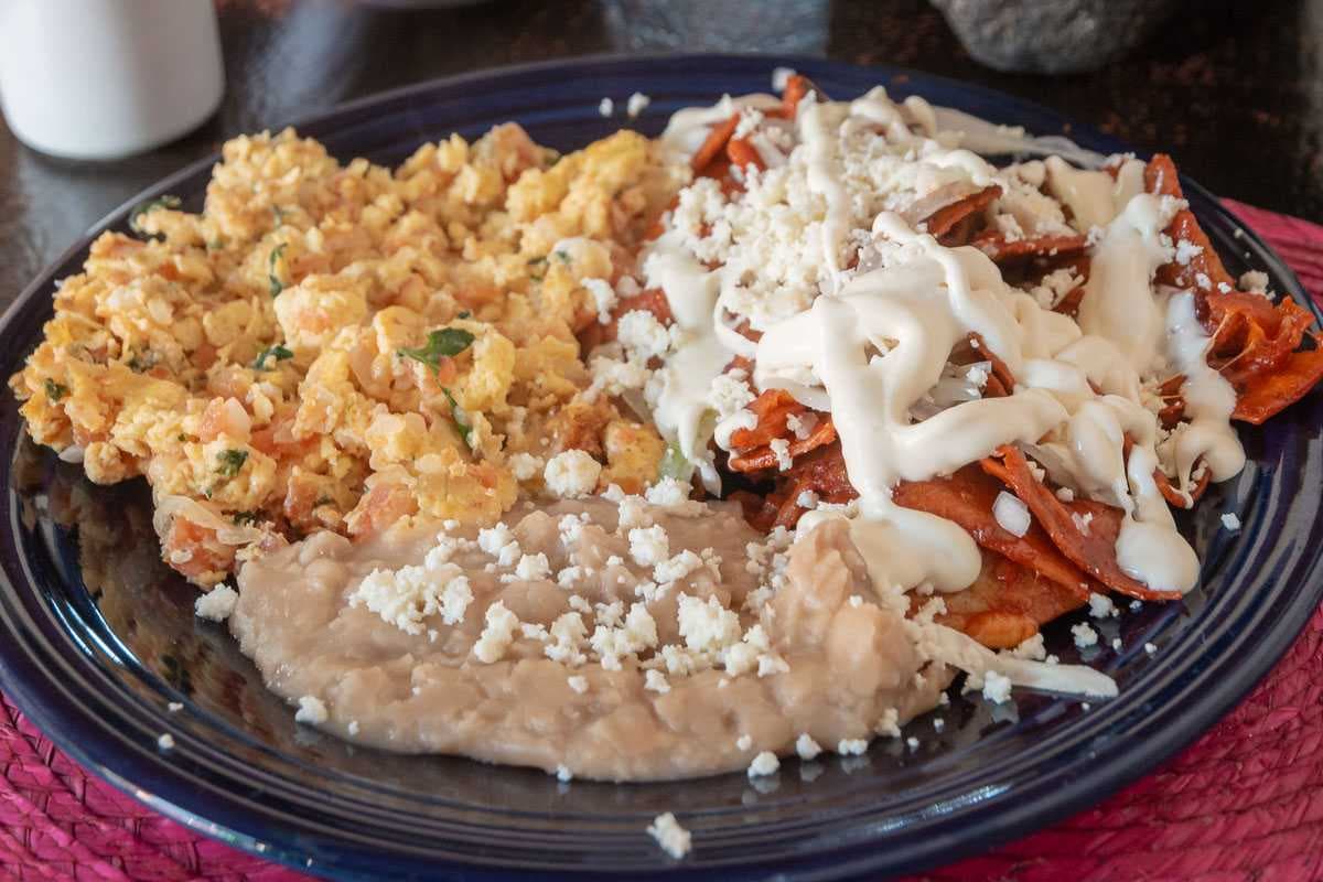 Chilaquiles with scrambled eggs a la mexicana, and beans.